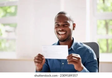 holding-paycheck-payroll-check-insurance-260nw-2309189357