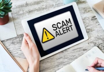 scam-alert-being-read-on-a-tablet-held-by-a-woman